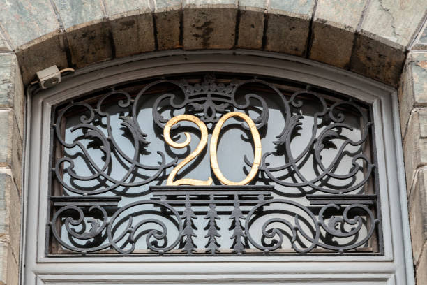 istock 20 numerals in copper fixed within metal filigree above a house door. 1480895581