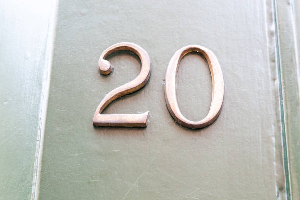 istock 20 numerals in copper fixed against a cream shiplap house wall. 1480895585
