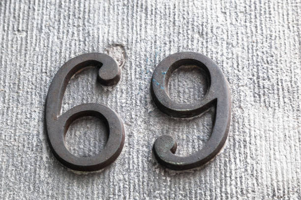 istock 69 numerals in cast steel fixed against a grey cement block. 1480895587