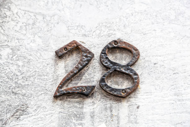 istock 29 numerals in cast steel fixed against a white and grey cement block. 1480895592