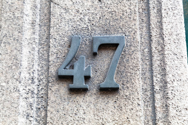 istock 47 numerals in cast steel fixed against a grey cement block. 1480895596