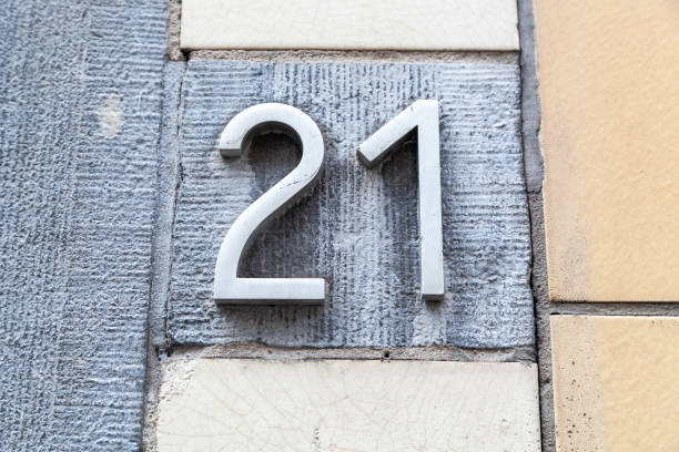 istock 21 numerals in cast brushed steel fixed against a grey cement block. 1480895598