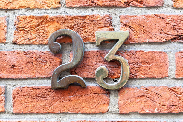 istock 23 numerals in cast bronze or steel fixed against a red brick wall. 1480895599
