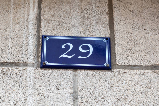 istock 29 number on blue metal plaque on grey brick facade. 1480895601