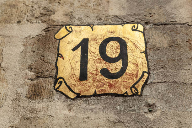 istock 19 number decorative font and gold scroll backgroud handpainted on house wall. 1480895605