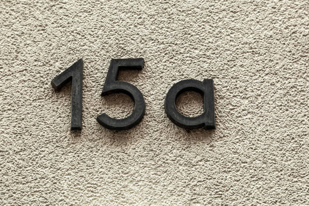istock 15a numerals in cast steel fixed against a grey cement block. 1480895610