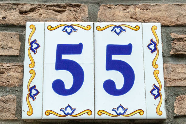 istock 55 ceramic decorative number plaque on cream brick house facade. 1480895611