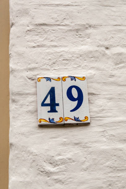 istock 49 ceramic decorative number plaque on white rendered cement house facade. 1480895615