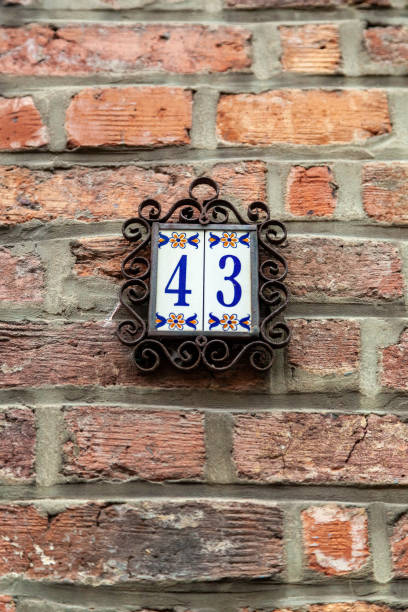 istock 43 ceramic decorative number plaque on red brick house facade. 1480895616