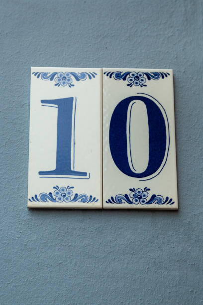 istock 10 ceramic decorative number plaque on blue rendered cement house facade. 1480895617