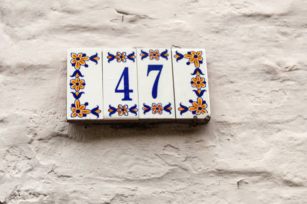 istock 47 ceramic decorative number plaque on white rendered cement house facade. 1480895625