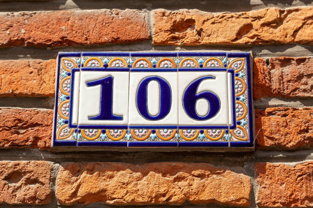 istock 106 ceramic decorative number plaque on red brick house facade. 1480895626