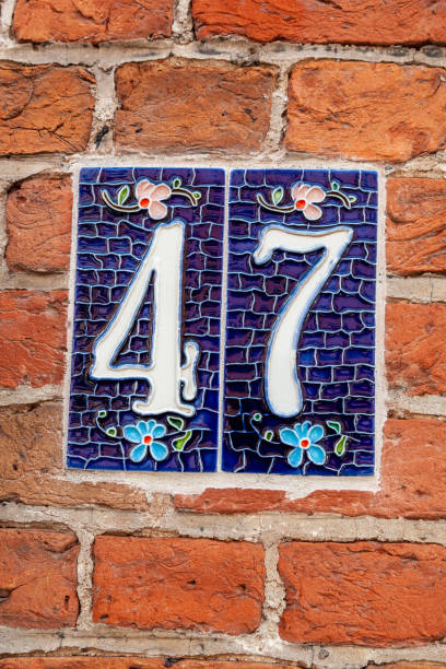 istock 47 ceramic decorative number plaque on red brick house facade. 1480895627