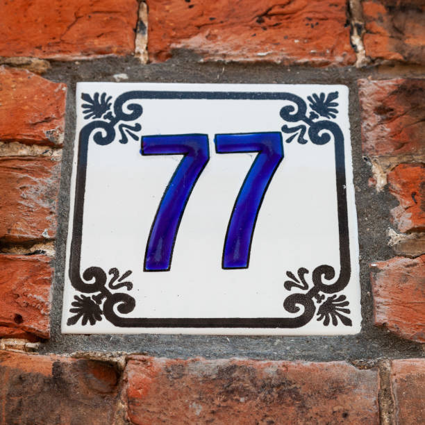 istock 77 ceramic decorative number plaque on red brick house facade. 1480895630