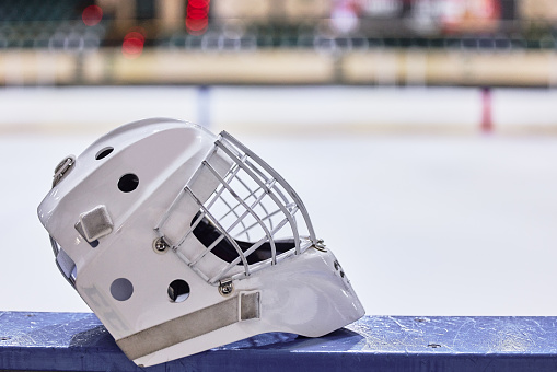 Ice hockey helmet, sport safety and blurred background for safety, health or head care in game. Hockey, sports and protective gear for concussion, brain damage or skull fracture at stadium in Toronto