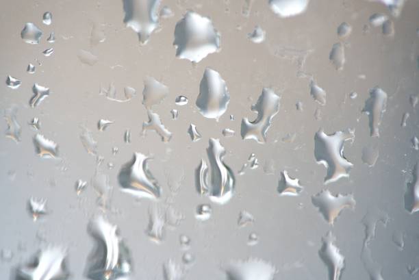 Shot in Shanghai, one of the busiest cities in China. Summer storm brings rain, that leaves a trail of water on window glasses. It gives a light grey background, abstract and perfect as backdrops.