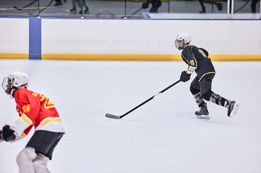 A field hockey player about to pass the ball