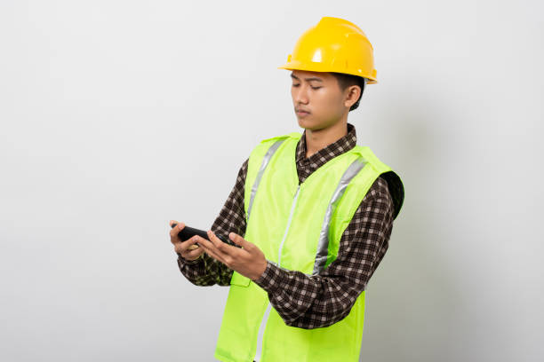 istock Young asian construction worker smiling happy using smartphone isolated on white background 1480903674