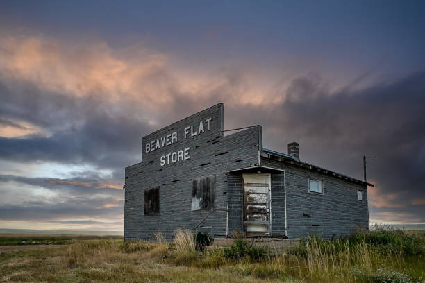 Beaver Flat, SK, Canada- July 16, 2021: Stormy skies over the abandoned Beaver Flat General Store near Swift Current, Saskatchewan