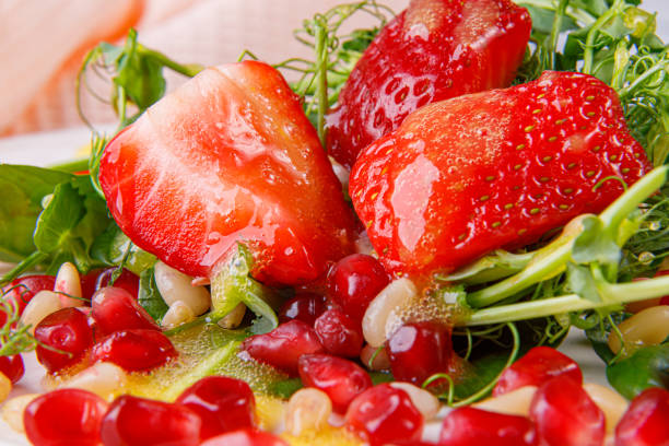 istock Salad with microgreens, strawberries, pine nuts and pomegranate seeds. Close-up. 1480909449