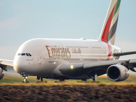 An Emirates Airbus A380-842, registration A6-EUW, powers down the main north-south runway of Sydney Kingsford-Smith Airport in taking off.  She is heading to Dubai as flight EK415.   This image was taken from the Botany side of the Cooks River in Kyeemagh, Sydney at sunrise on 8 April 2023.