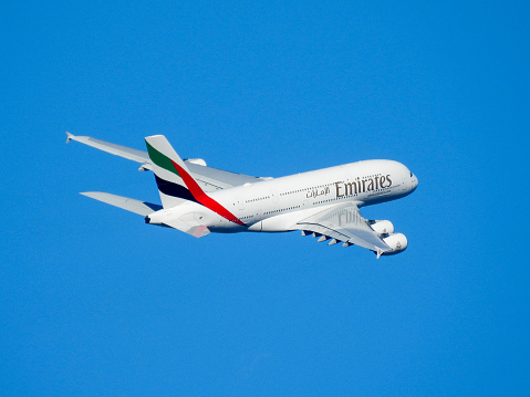 An Emirates Airbus A380-842, registration A6-EVQ, has taken off to the west from Sydney Kingsford-Smith Airport and heading to Christchurch as flight EK412.   This image was taken from Nigel Love Bridge off Airport Drive, Mascot on a sunny and windy morning on 8 April 2023.