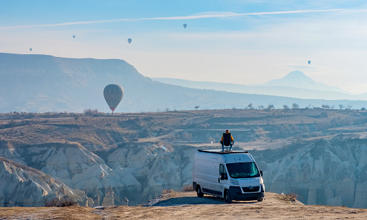 Goreme, Turkey - January 10, 2023: camping with the view hot air balloons flying above Love Valley in Cappadocia