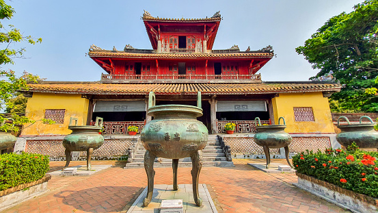 Hue, Vietnam - March 15, 2021 : Hien Lam Pavilion And Nine Tripod Cauldrons In Front Of The Mieu Temple In Hue Imperial Citadel. The Imperial Citadel Of Hue, A UNESCO Cultural Heritage Is A Major Tourist Destination In Vietnam.