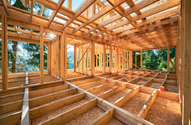 istock Wooden frame house under construction near forest. 1480912180