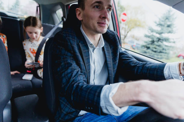 istock Father Driving his two daughters in car 1480912987