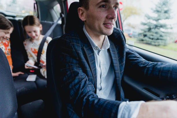 istock Father Driving his two daughters in car 1480912989