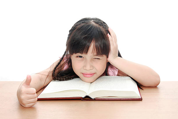 istock Intelligent little girl  reading a book 148091379