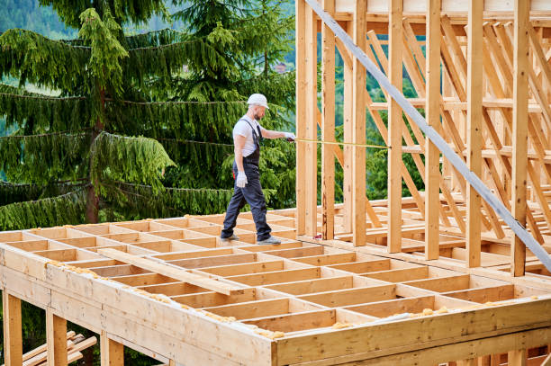 istock Carpenter measures distance with tape measure while building wooden frame house. 1480913988
