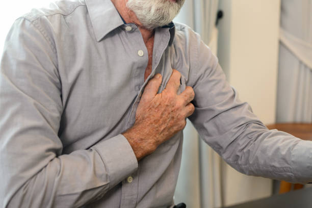 istock Senior man holding hand on chest and suffering from heart problem 1480914048