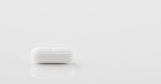 istock One white pill on a white table. Global healthcare concept. 1480920026