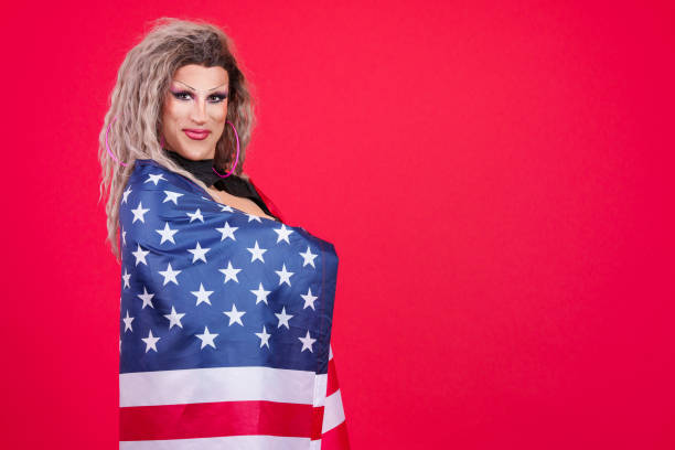 istock Transgender person looking at camera wrapping with an american flag 1480920699