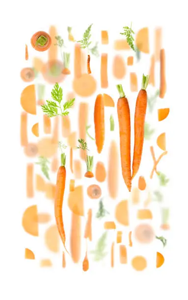 Abstract background made of Carrot fruit pieces, slices and leaves isolated on white.