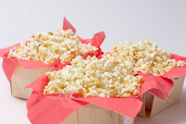 istock Popcorn presented on red paper napkins inside wooden bowls. 1480924099