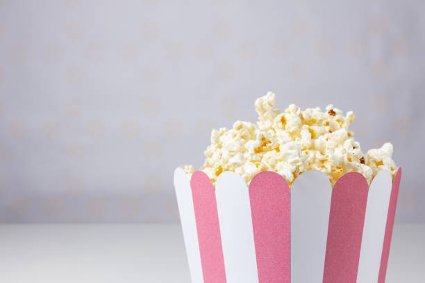 istock Close-up of popcorn inside a striped bowl. 1480924148