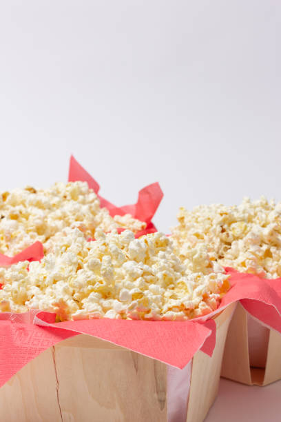 istock Popcorn presented on red paper napkins inside wooden bowls. 1480924154