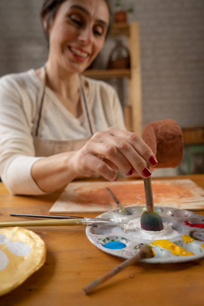 istock Woman painting a pottery 1480924415