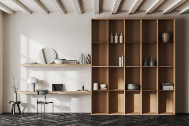 istock Beige workplace interior with laptop on desk and decoration on shelf 1480927540