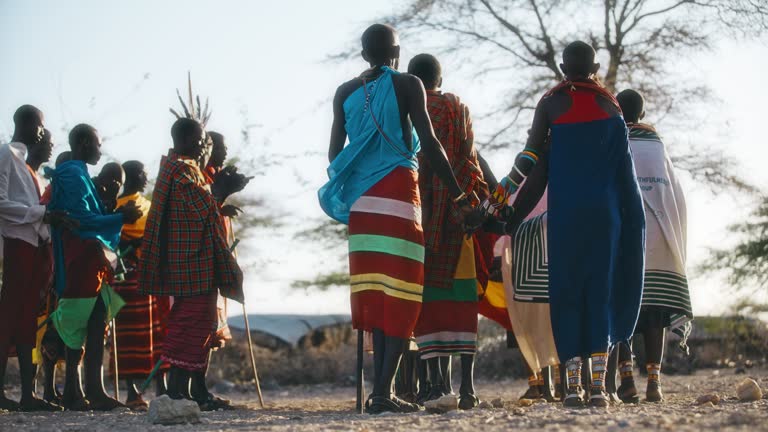 SLO MO View of a group of Samburu women and men singing and dancing in pairs
