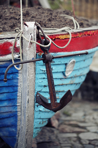 Old blue and red boat with black anchor