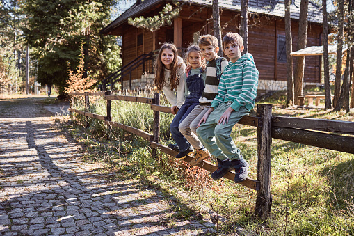 Beautiful children are enjoying beautiful forest, playing, smiling, having fun.