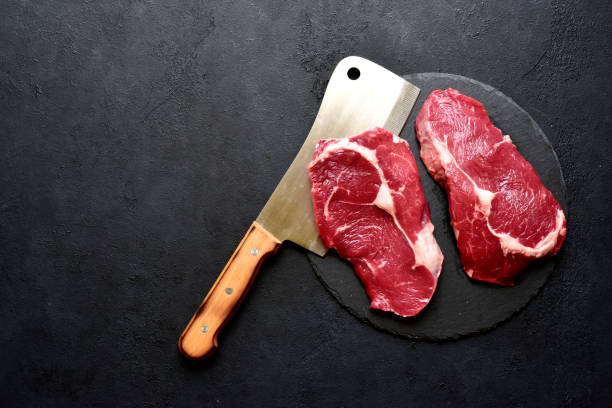 istock Raw organic rib eye steak with ingredients for making. Top view with copy space. 1480936816