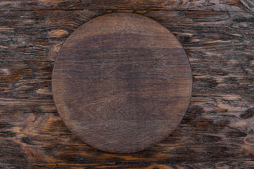 Empty round board for cutting food and cooking on the background.Space for text. Top view.