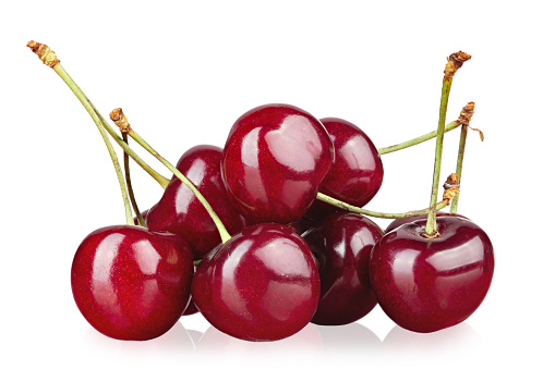Lots of ripe red cherries. Isolated on white background.