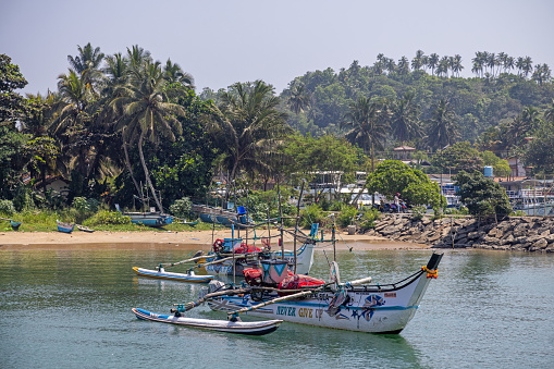Tourists and speedboat in action on a tropical island in Thailand