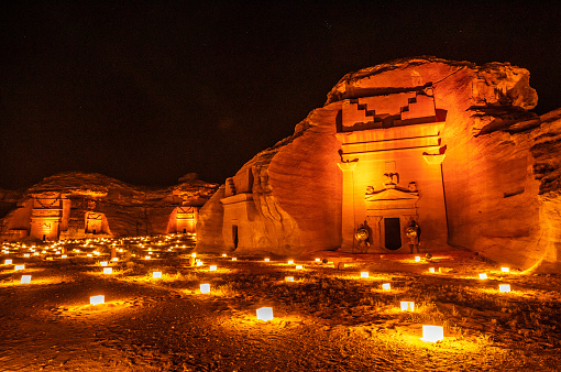 Ancient tombs of Hegra city illuminated during the night, Al Ula, Saudi Arabia